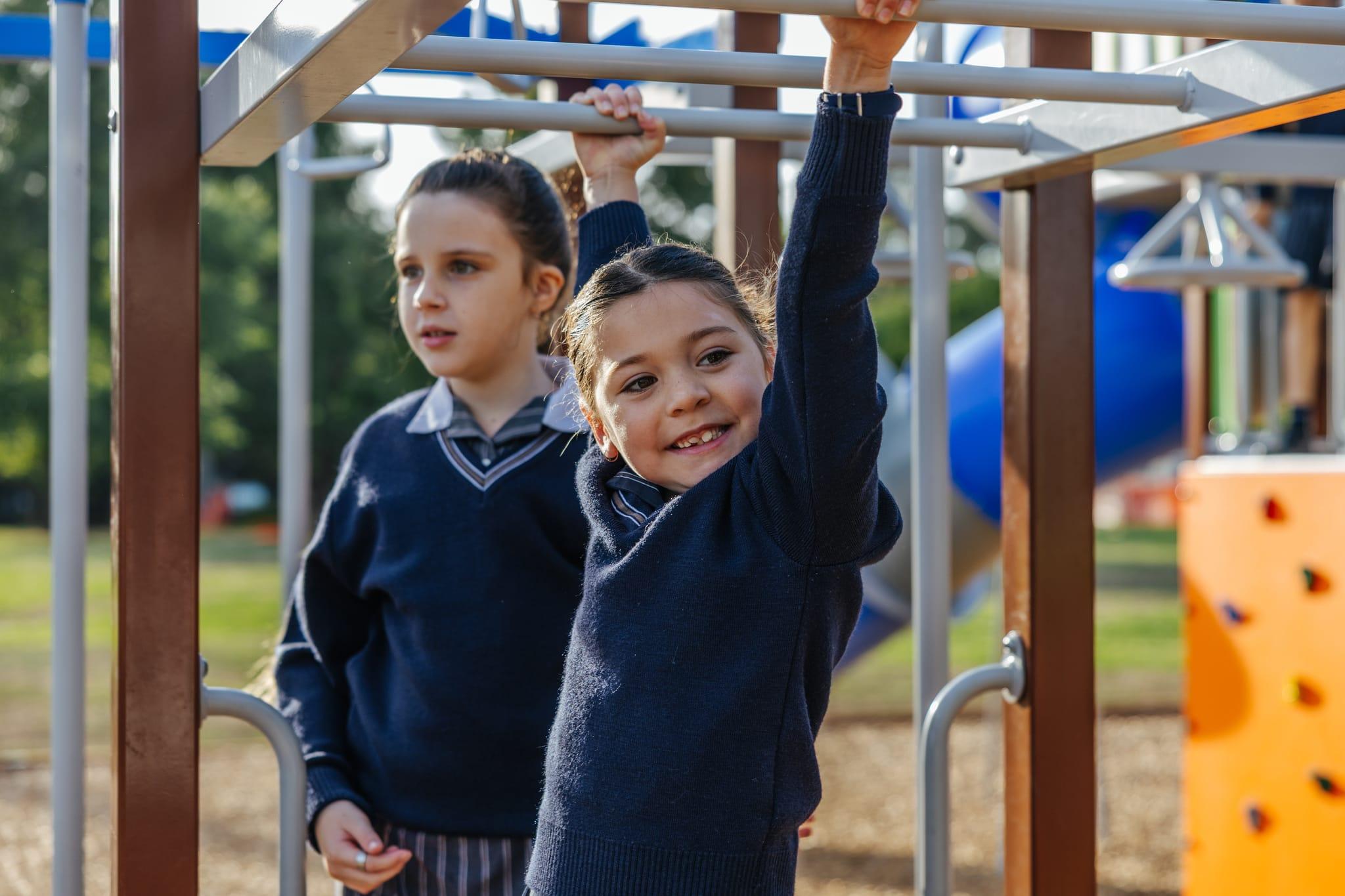 Two happy primary school students on the playground at Australian Christian College Benalla, highlighting the vibrant school environment for tours.