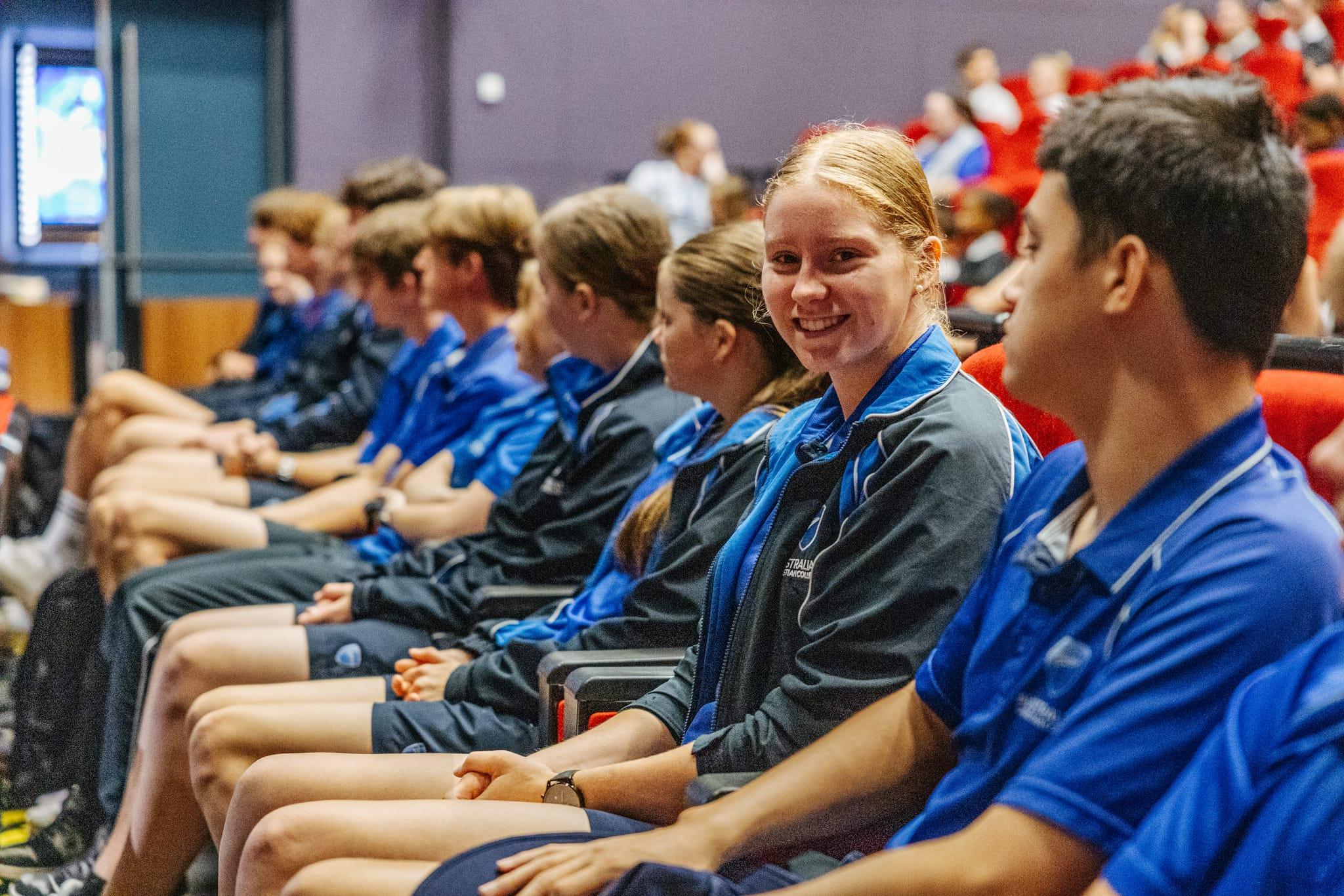 Secondary students in uniform sitting and smiling in an auditorium at Australian Christian College Benalla, highlighting Christian education in Victoria.