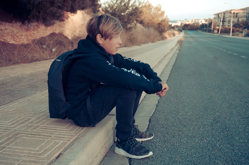 Boy sitting by himself after school