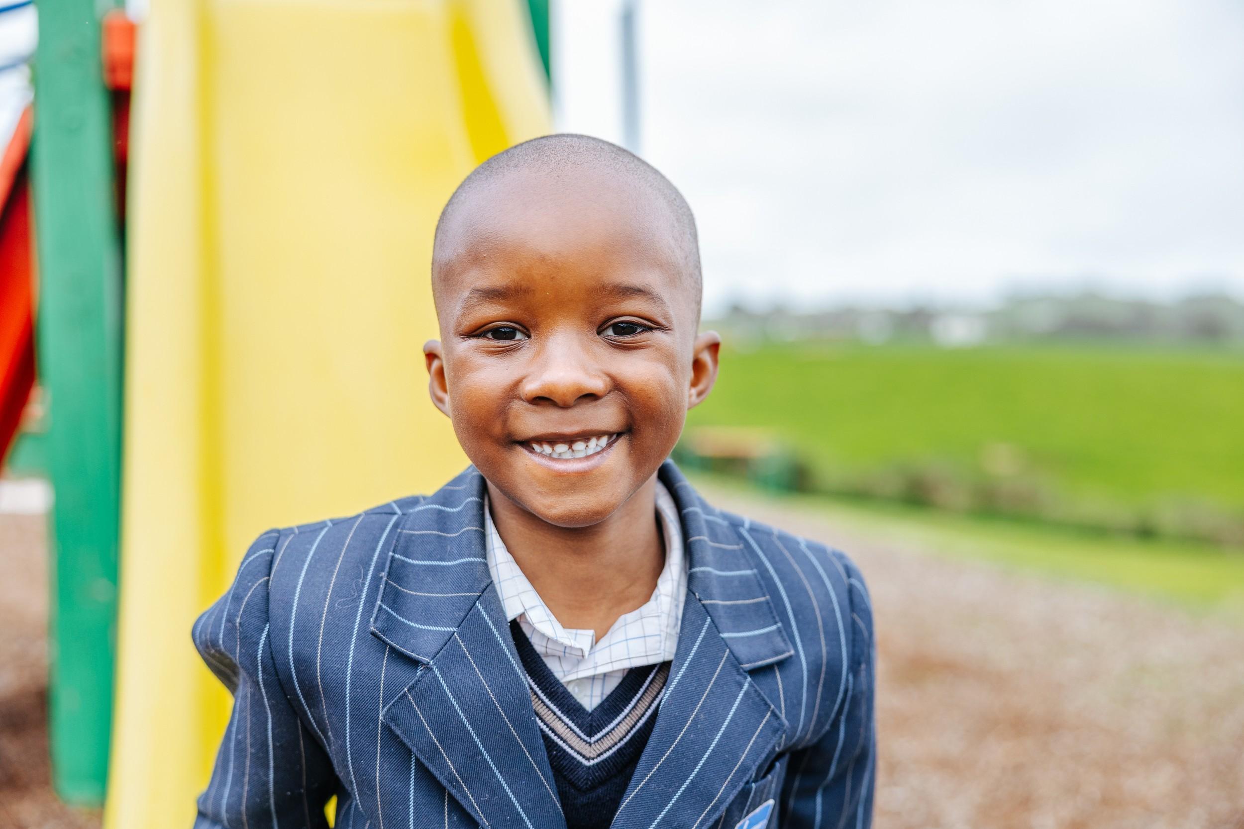 Smiling ACC Burnie student in uniform on the school playground in Somerset, Tasmania.