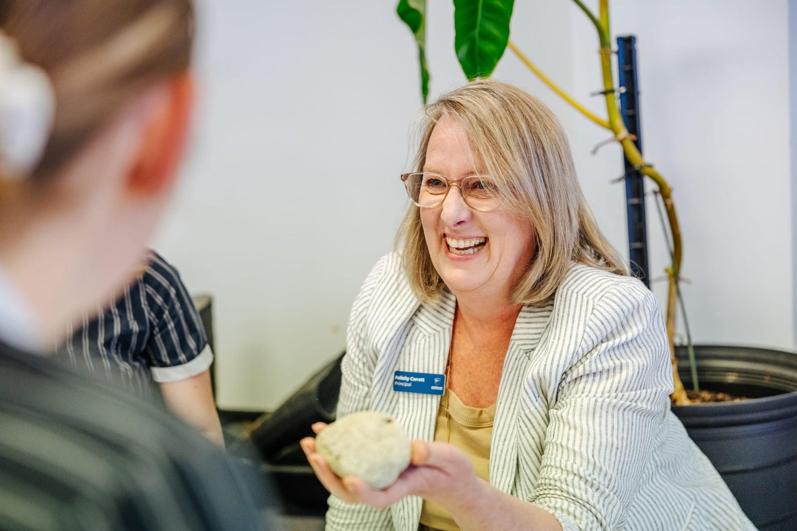 Teacher smiling and engaging a secondary student during a hands-on lesson at ACC Burnie in Tasmania