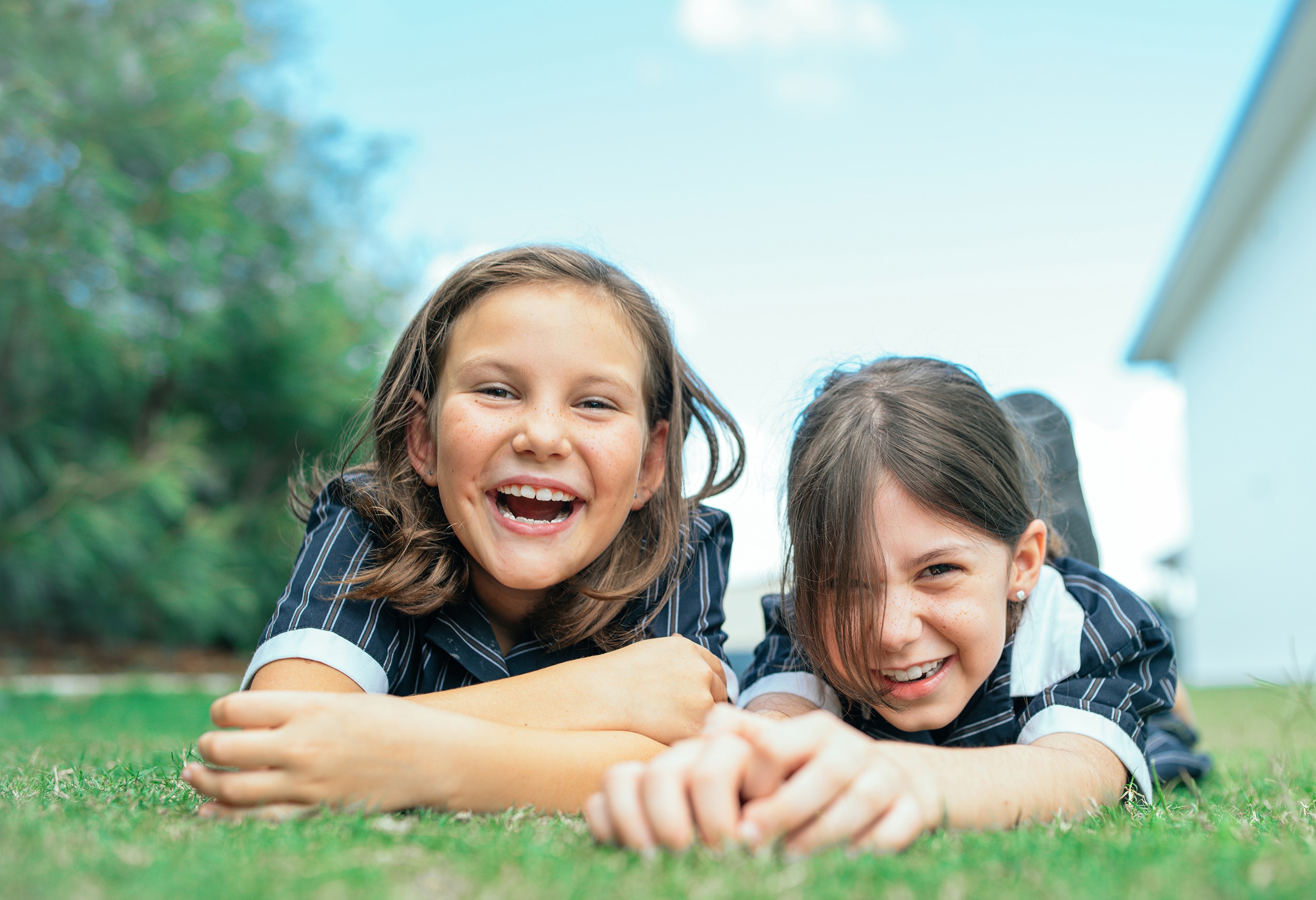 ACC Casey students laughing and lying in the grass