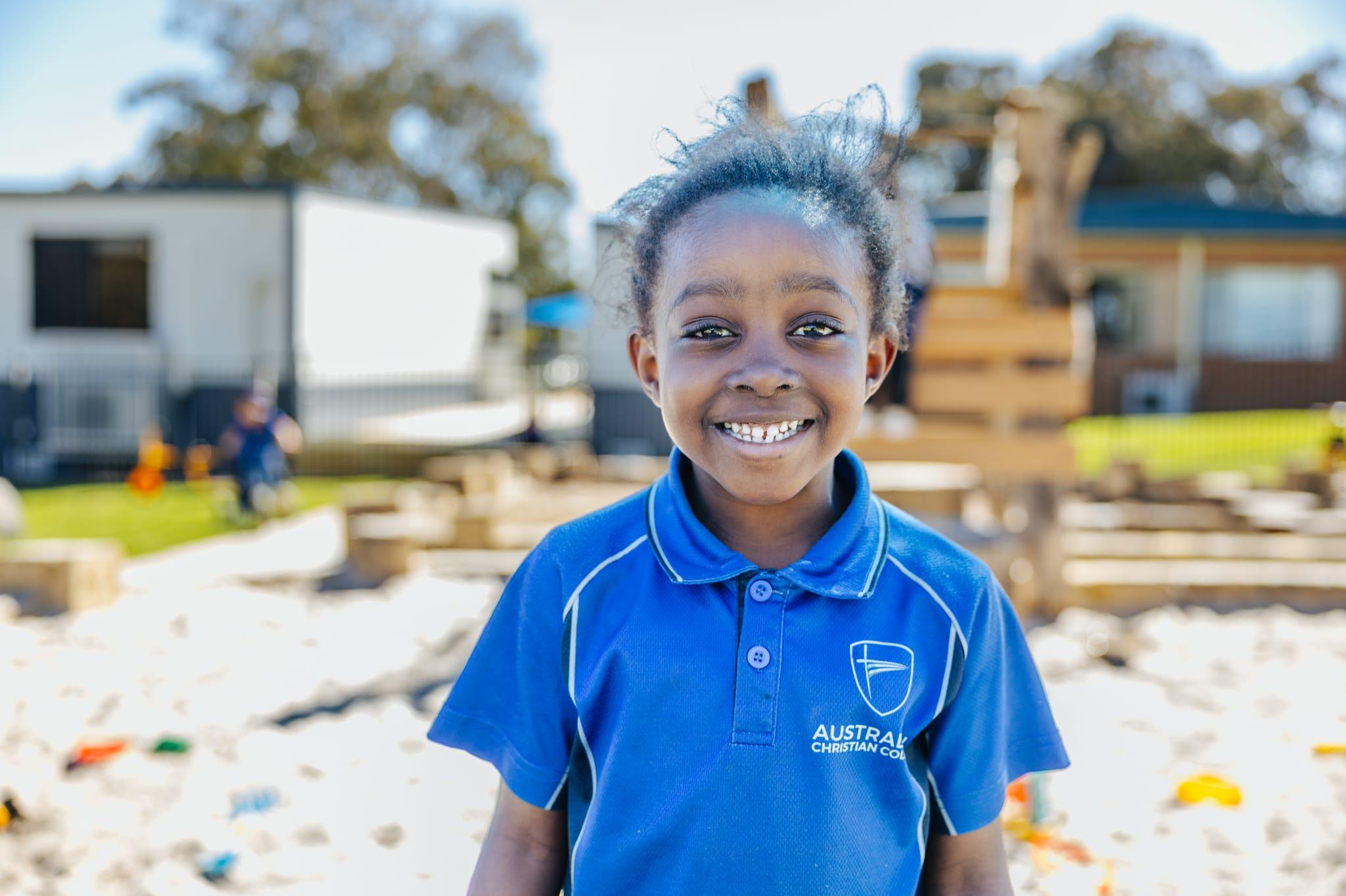 Kindergarten child enjoys a hands-on play-based learning session in the classroom at ACC Darling Downs.