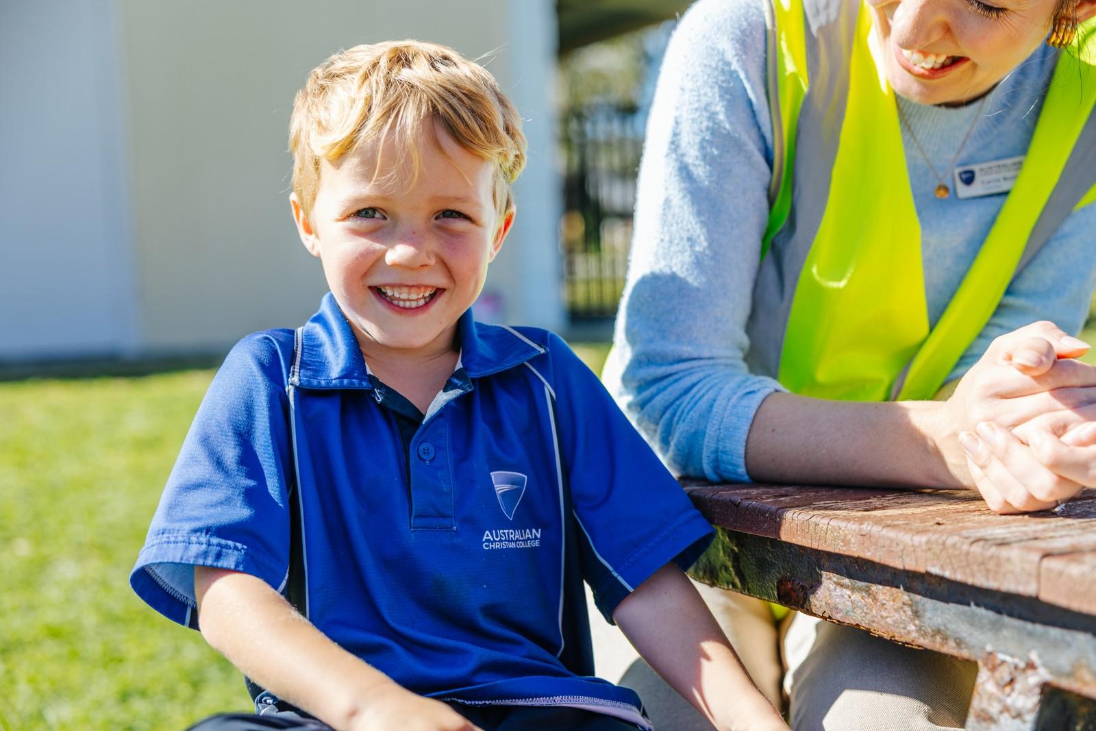 Kindergarten child works with a teacher on letters and sounds, building early literacy skills at ACC Darling Downs.