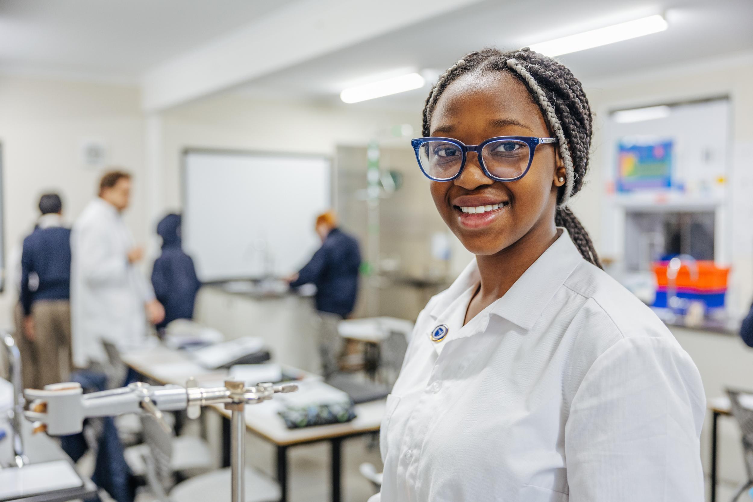 Smiling secondary student in an apron during a creative class at ACC Darling Downs, ready for the high school journey ahead.