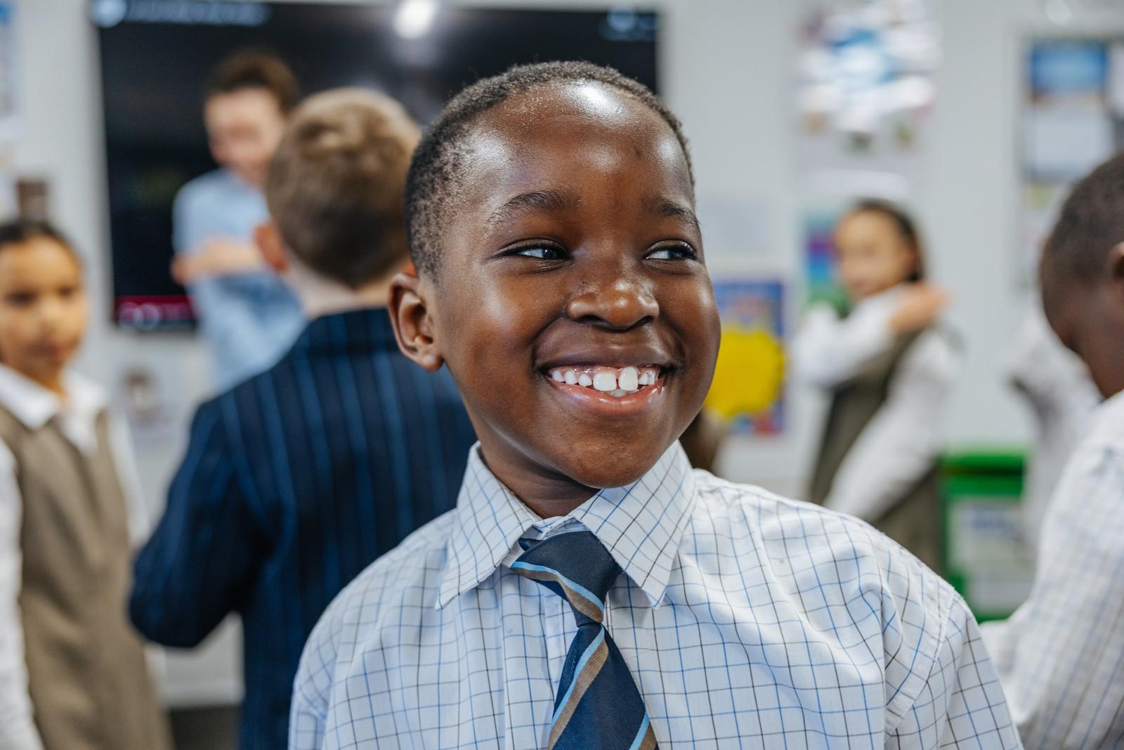 Smiling student in uniform in a nurturing Christian classroom at Darling Downs.