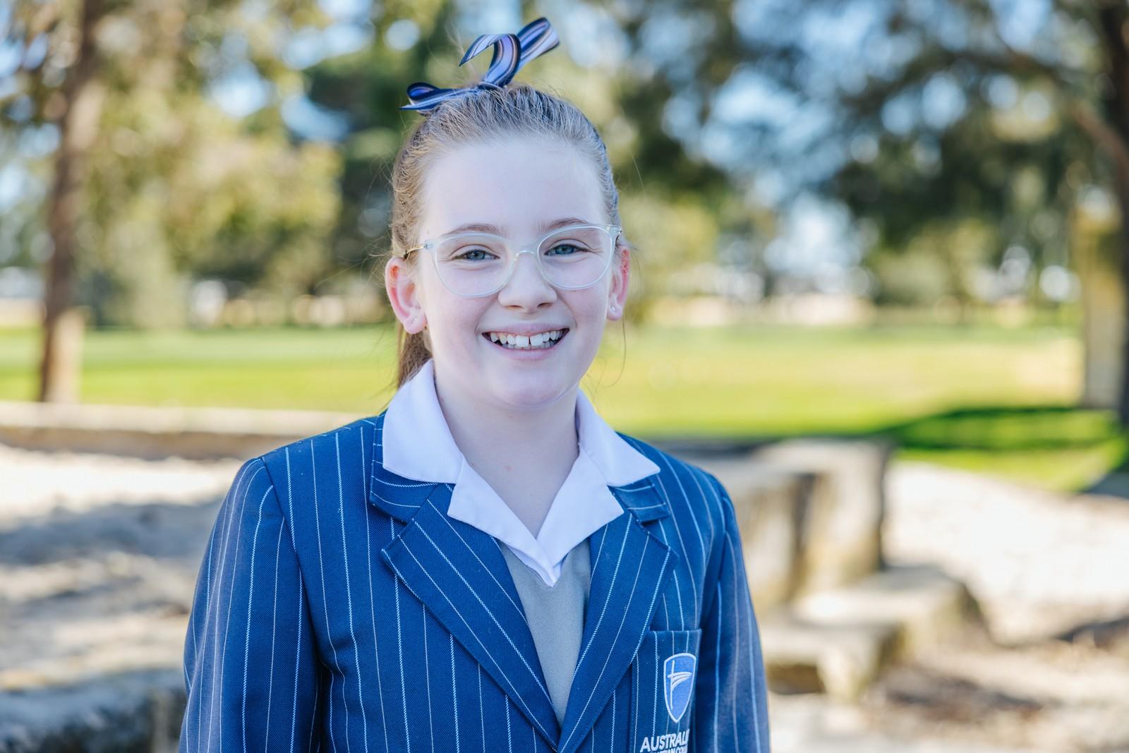 Smiling Darling Downs student in school uniform on campus, reflecting clear policies and open communication with families.