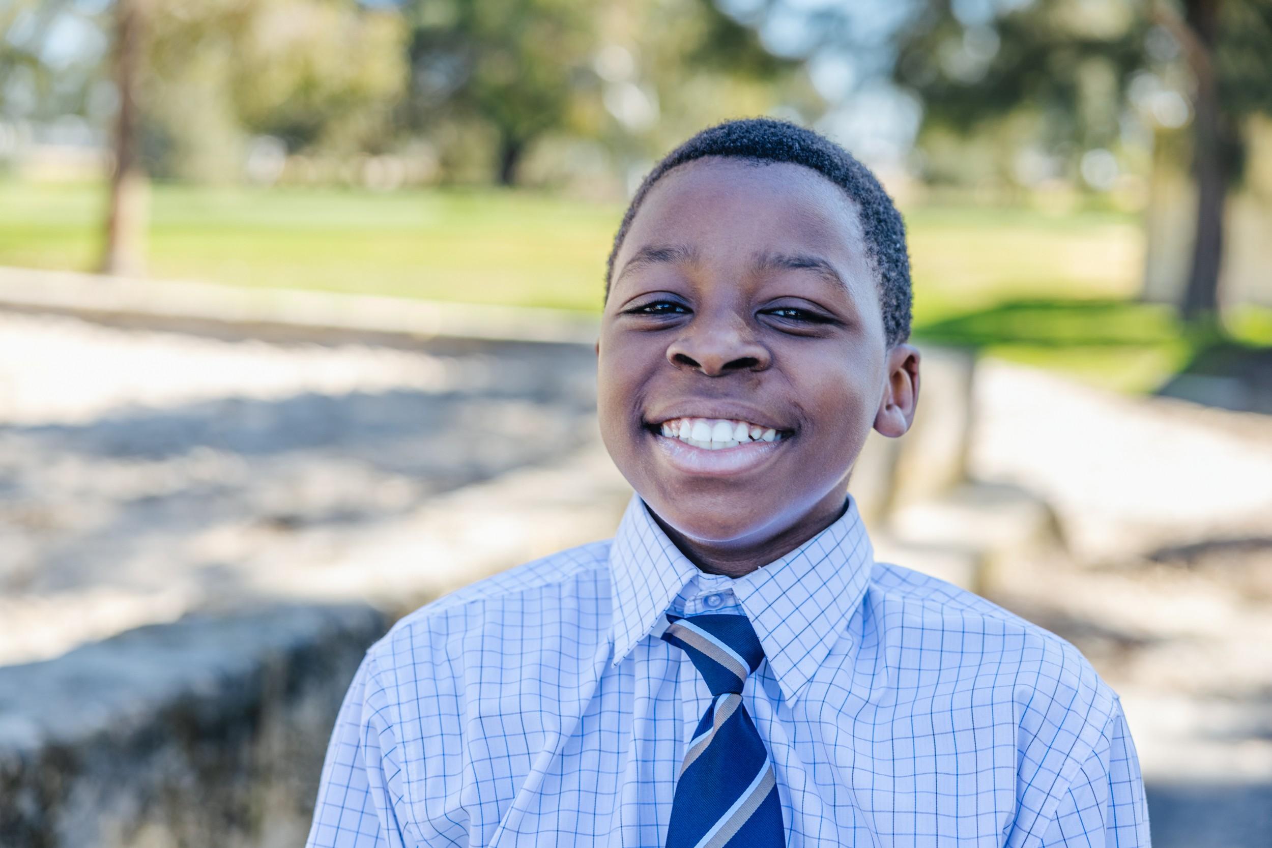 Smiling ACC Darling Downs student in school uniform outdoors on campus, reflecting a safe, supportive learning environment.