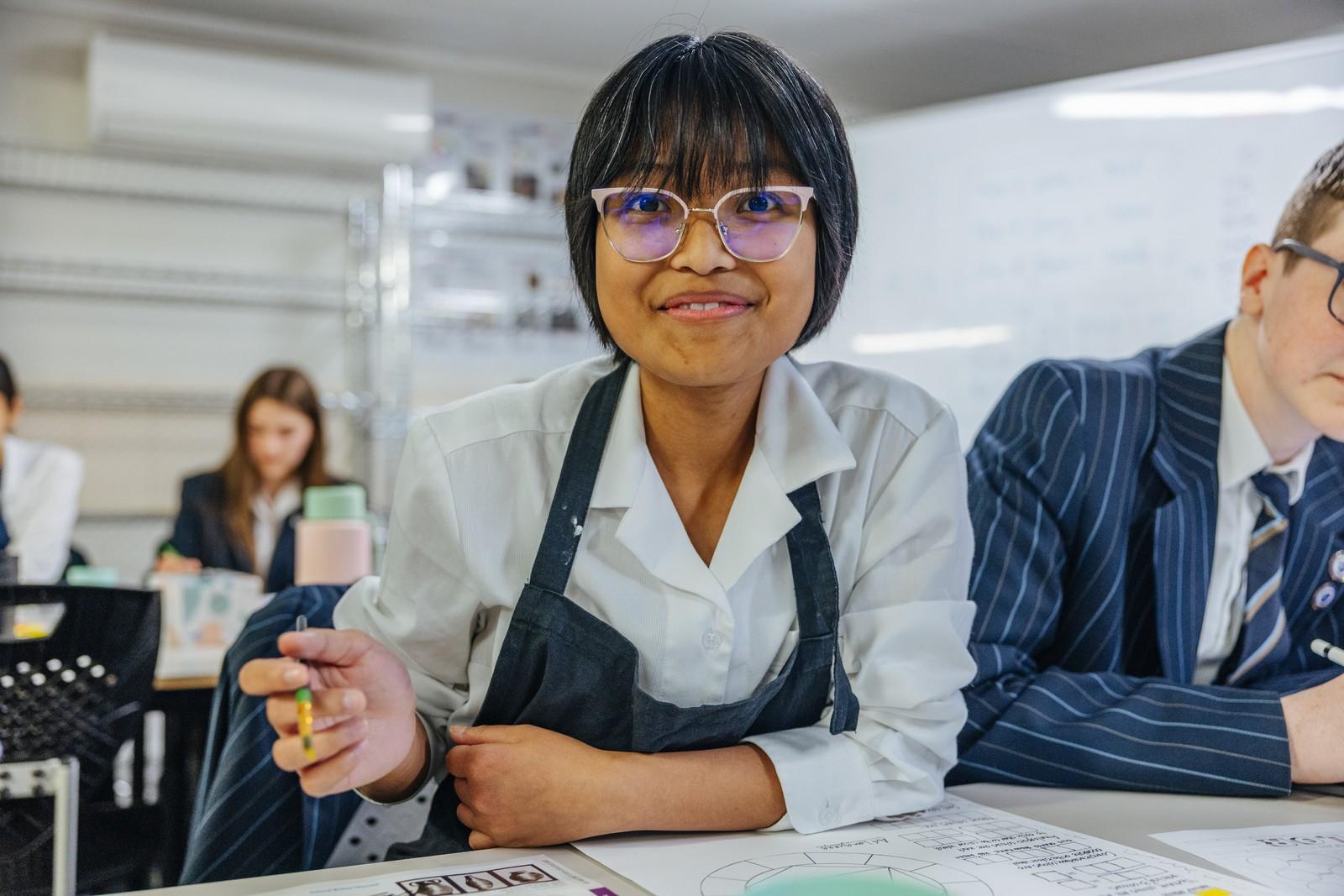 Student exploring creative talents in a hands-on food technology and arts class.