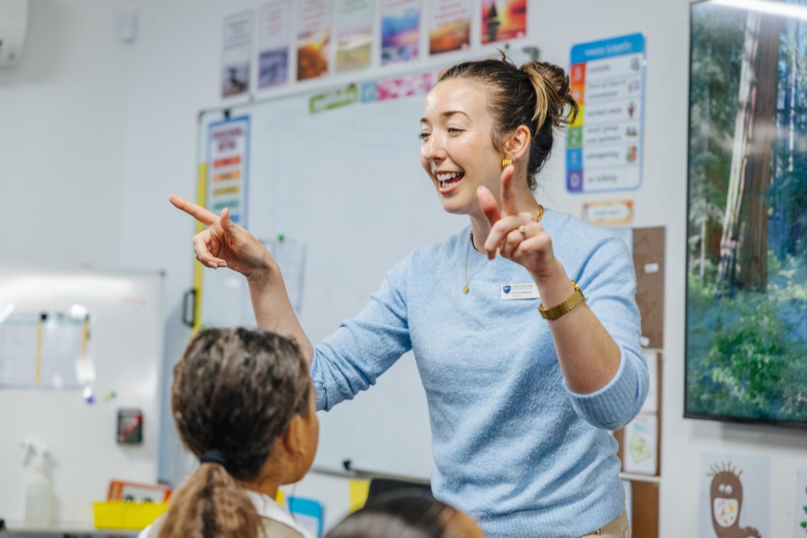 Teacher engaging students in a lively classroom discussion at ACC Darling Downs.