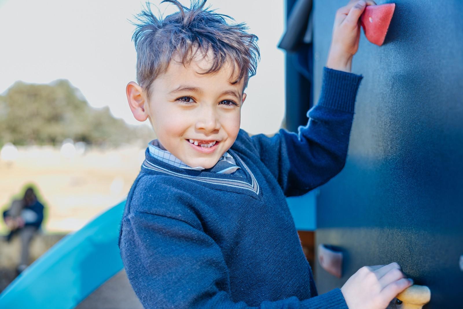 A young student at Darling Downs WA on the climbing wall, part of a community that knows and cares for them.