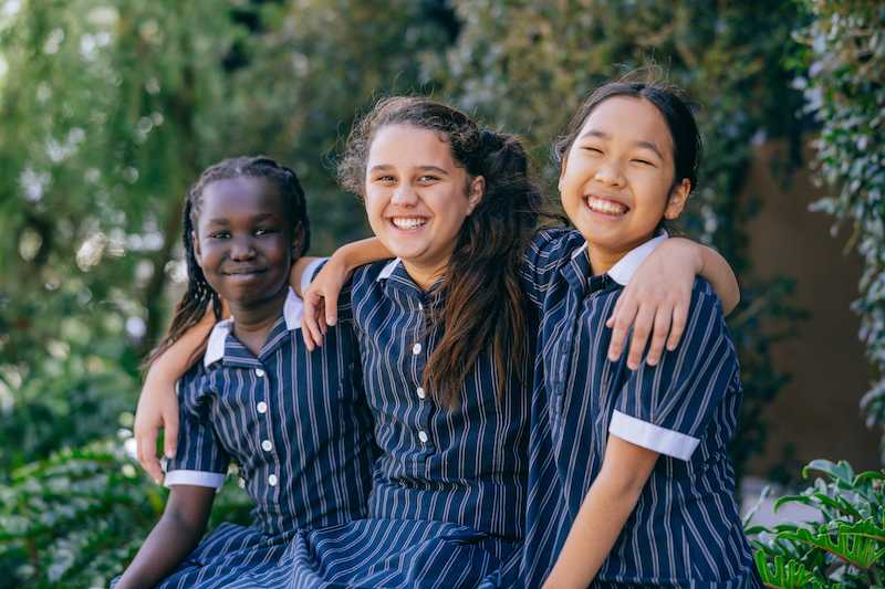 Group of secondary students smiling together