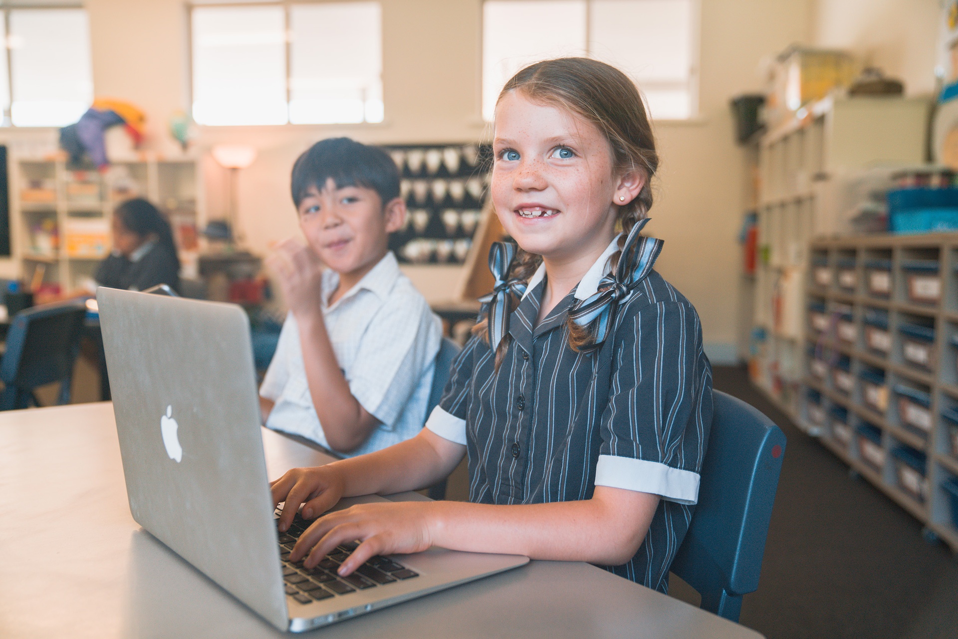 Class of primary students at ACC Darling Downs, girl with ribbons smiling