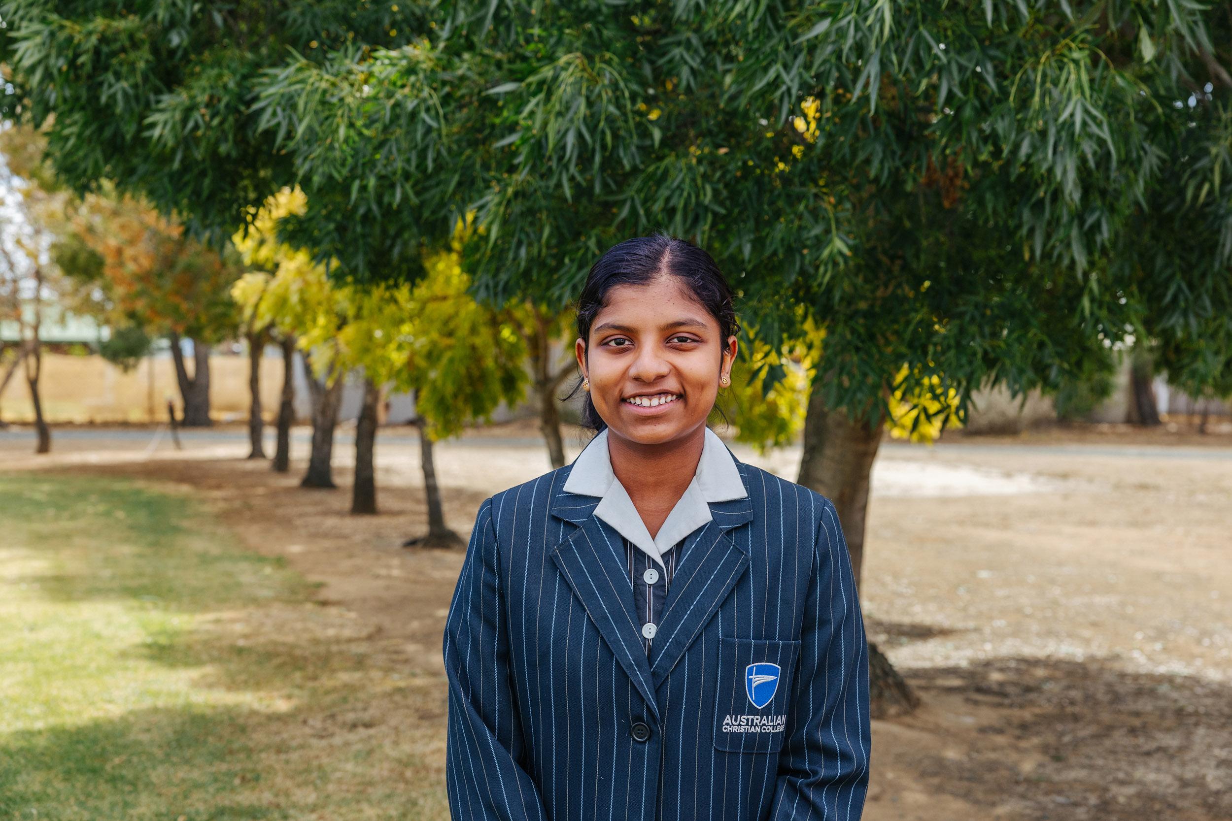 Smiling in full uniform beneath the gum trees, this student reflects the warmth and ease of a school that values belonging from the start.