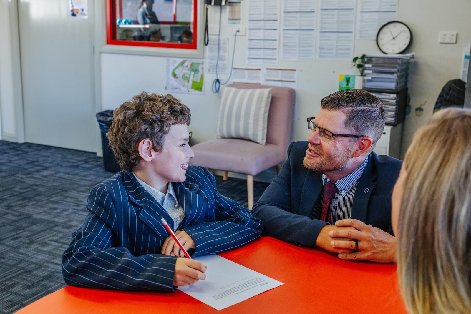 Principal and student share a meaningful moment during a meeting at ACC Echuca, reflecting a culture of trust, relational leadership, and Christ-centred support.