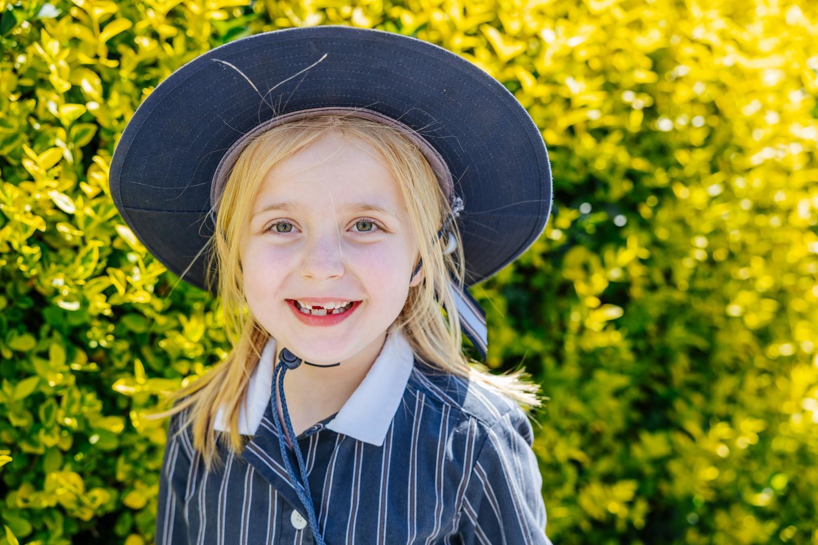 A young ACC Hobart TAS student smiles outdoors at the Geilston Bay campus, reflecting how every child is seen, heard and valued.