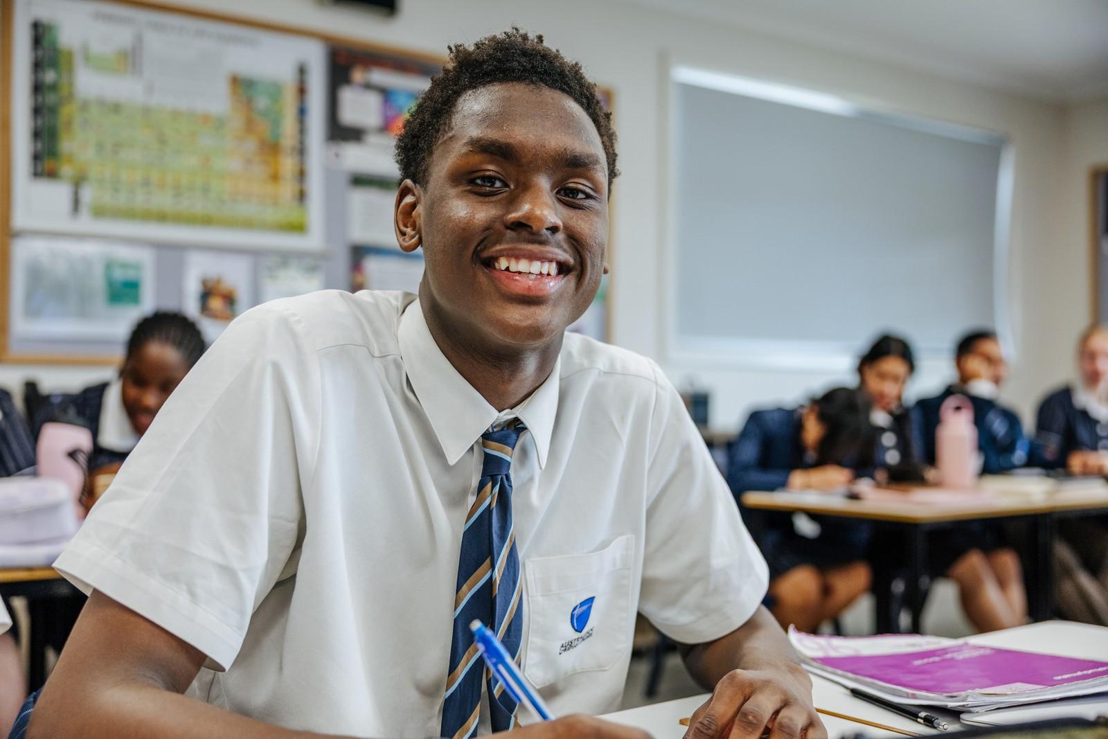 Smiling secondary student in ACC Hobart uniform in a classroom in Hobart, TAS