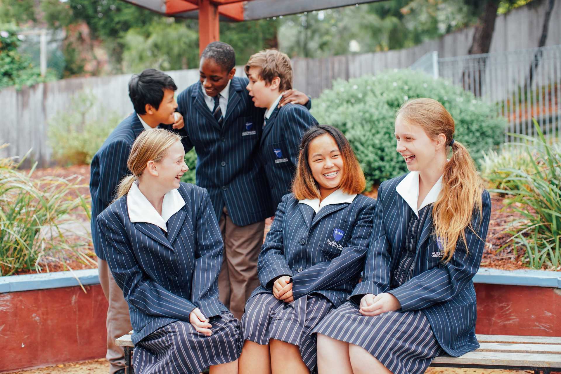 Hobart high school students sitting together at lunch time laughing