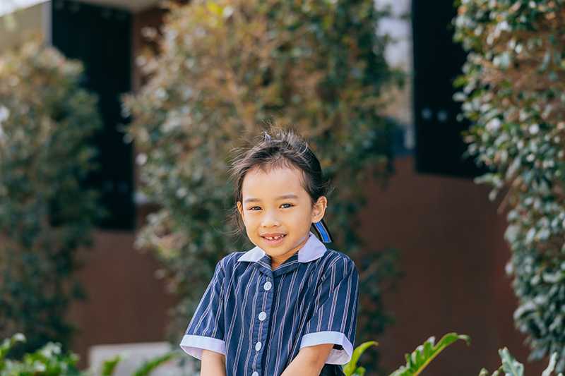 ACC Hobart primary school girl sitting smiling at camera