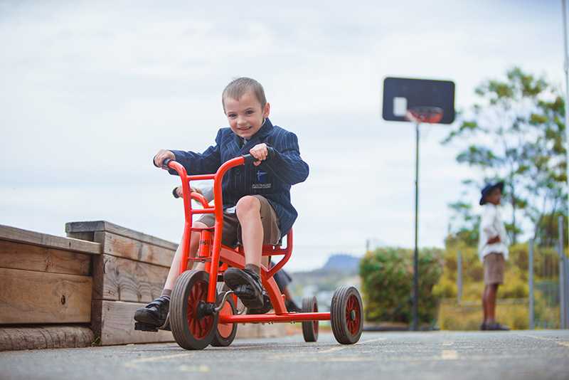 Boy riding tricycle at Hobart playgroup