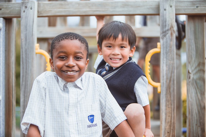 boys smiling on play equipment