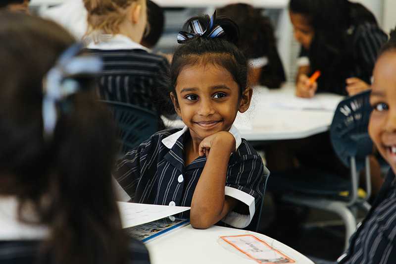 Smiling ACC Hume primary school student sitting in class