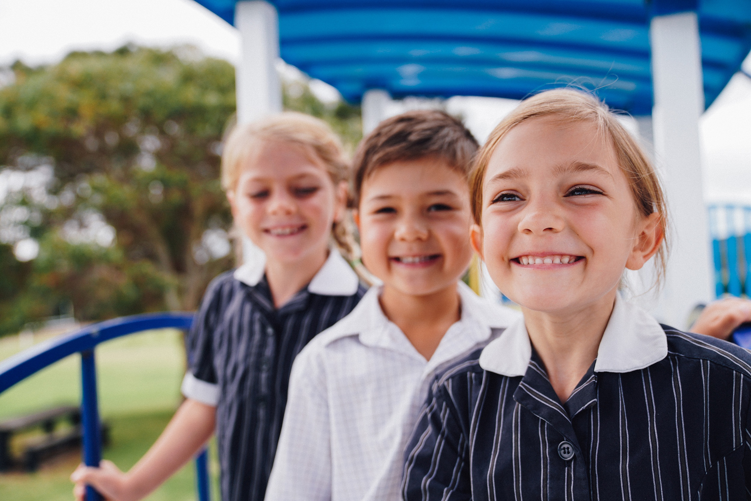 Three smiling Year 1 students from ACC Hume