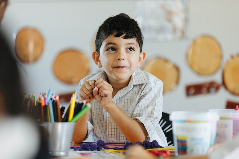ACC Hume primary boy sitting at desk with pencils in the foreground