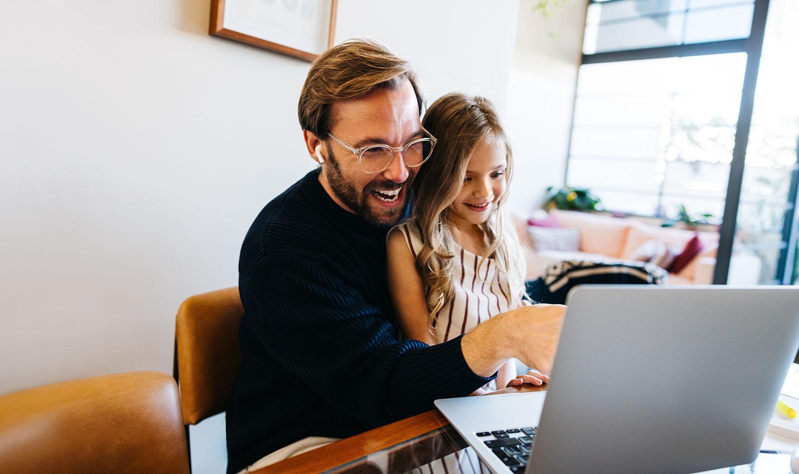 Parent supporting a child learning online at home, showing family and teacher-led support for ACC Launceston TAS Distance Education