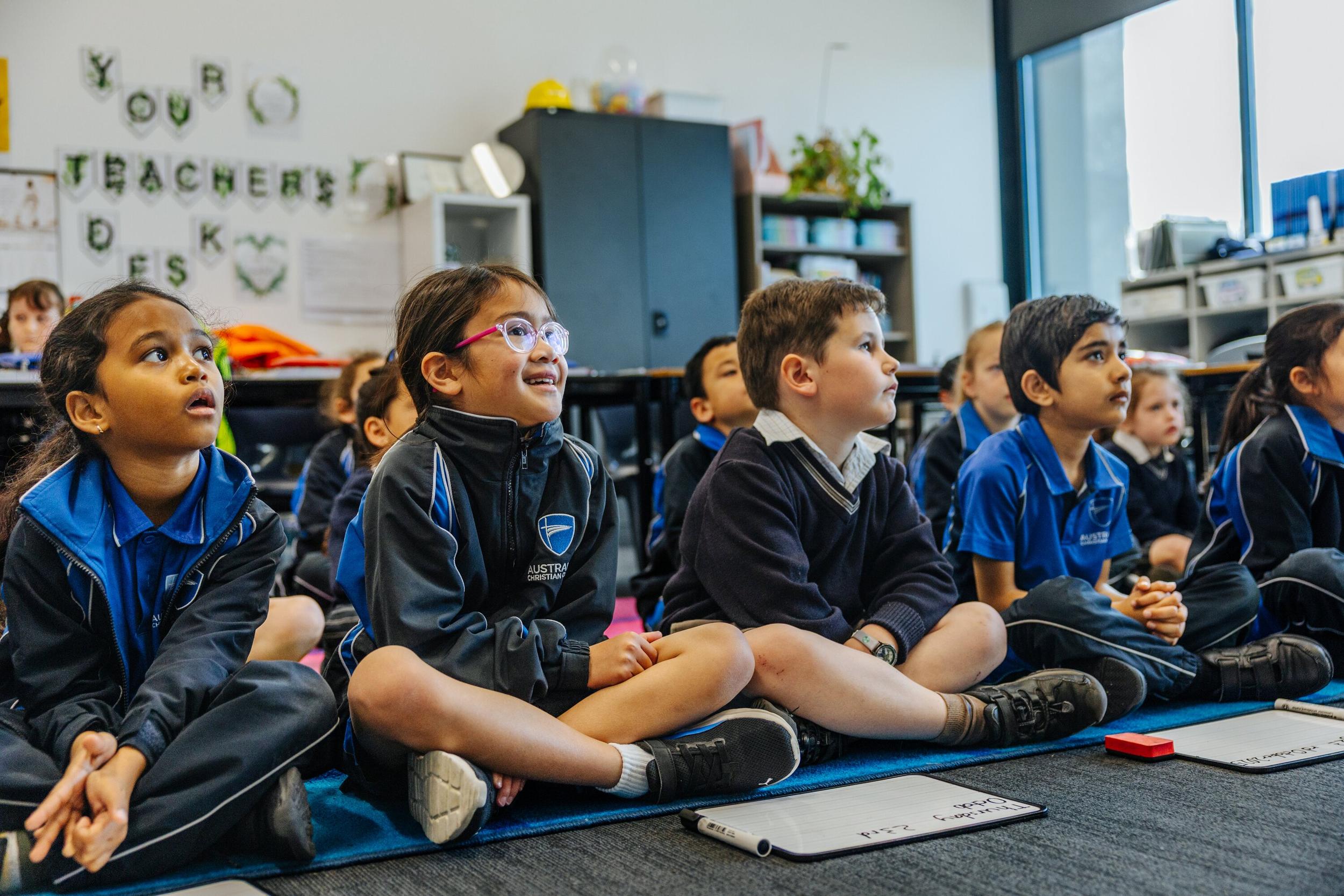 Primary students sitting on the classroom carpet at ACC Launceston
