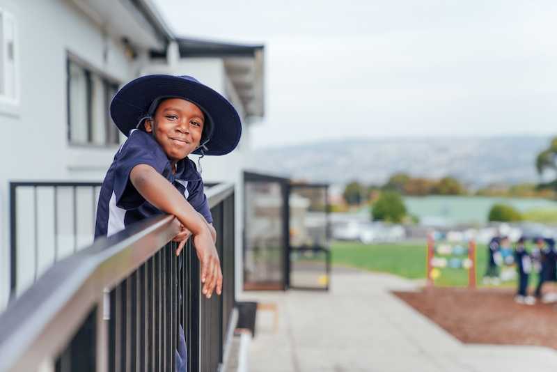 ACC Launceston student resting on guard rail wearing broad brim hat