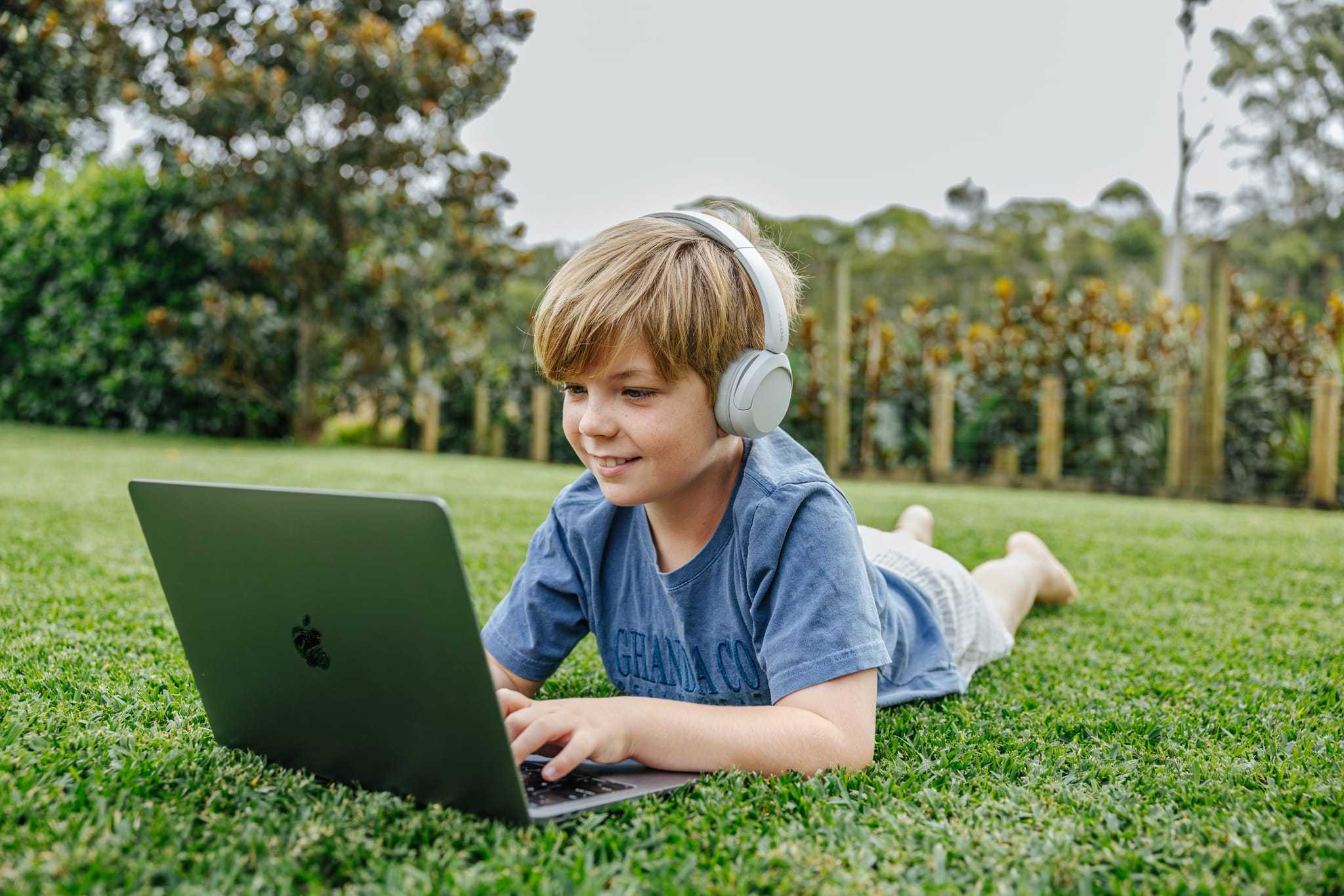 9 year old boy completing school work from backyard