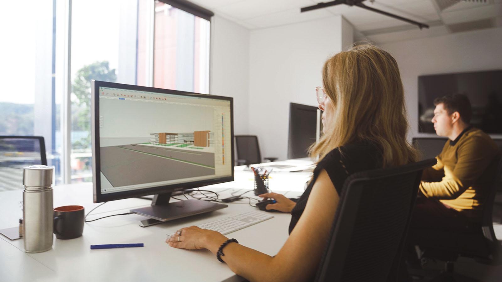 CEM staff focused at a computer monitor