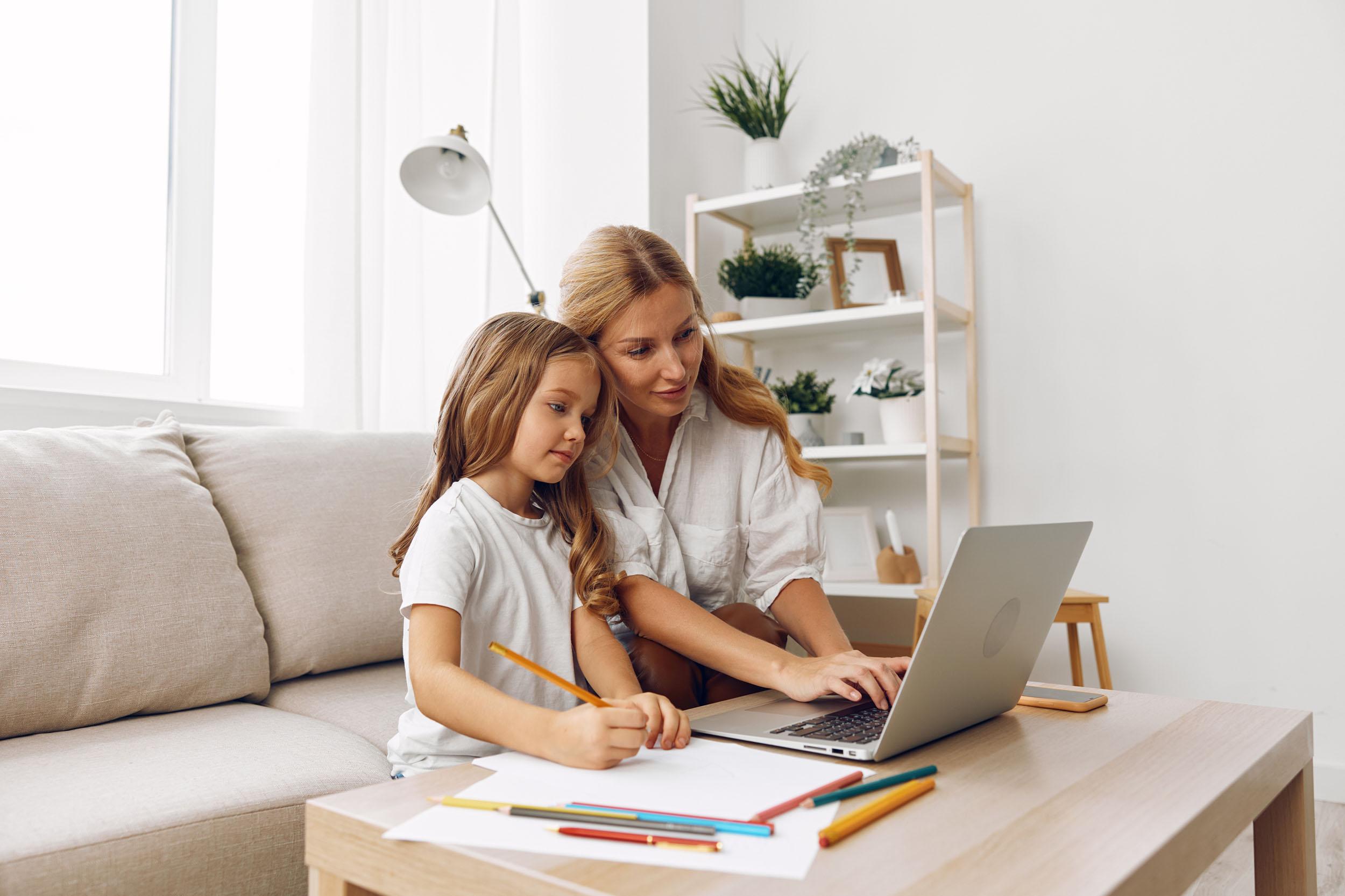 Primary student learning online at home with headphones