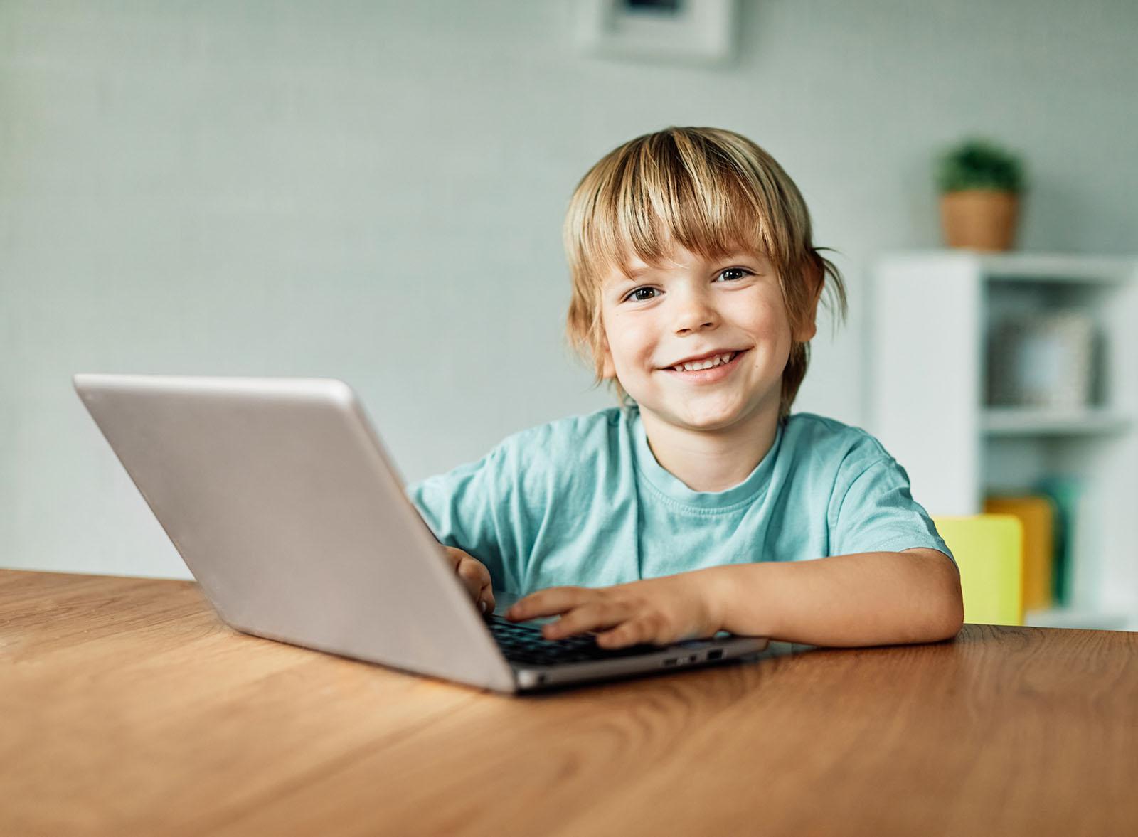 Distance education student studying at home wearing headphones and taking notes