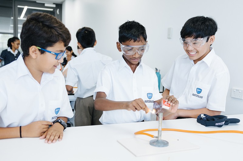 Students in science lab with bunsen burner