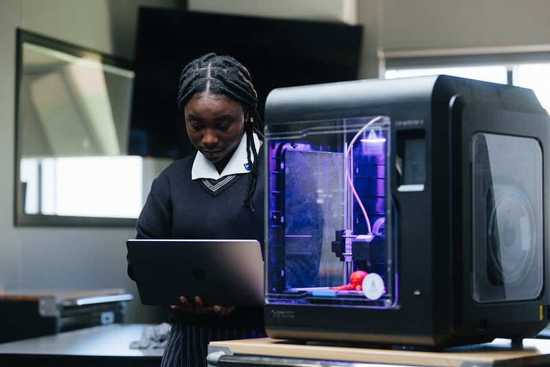 Female student using 3D printer