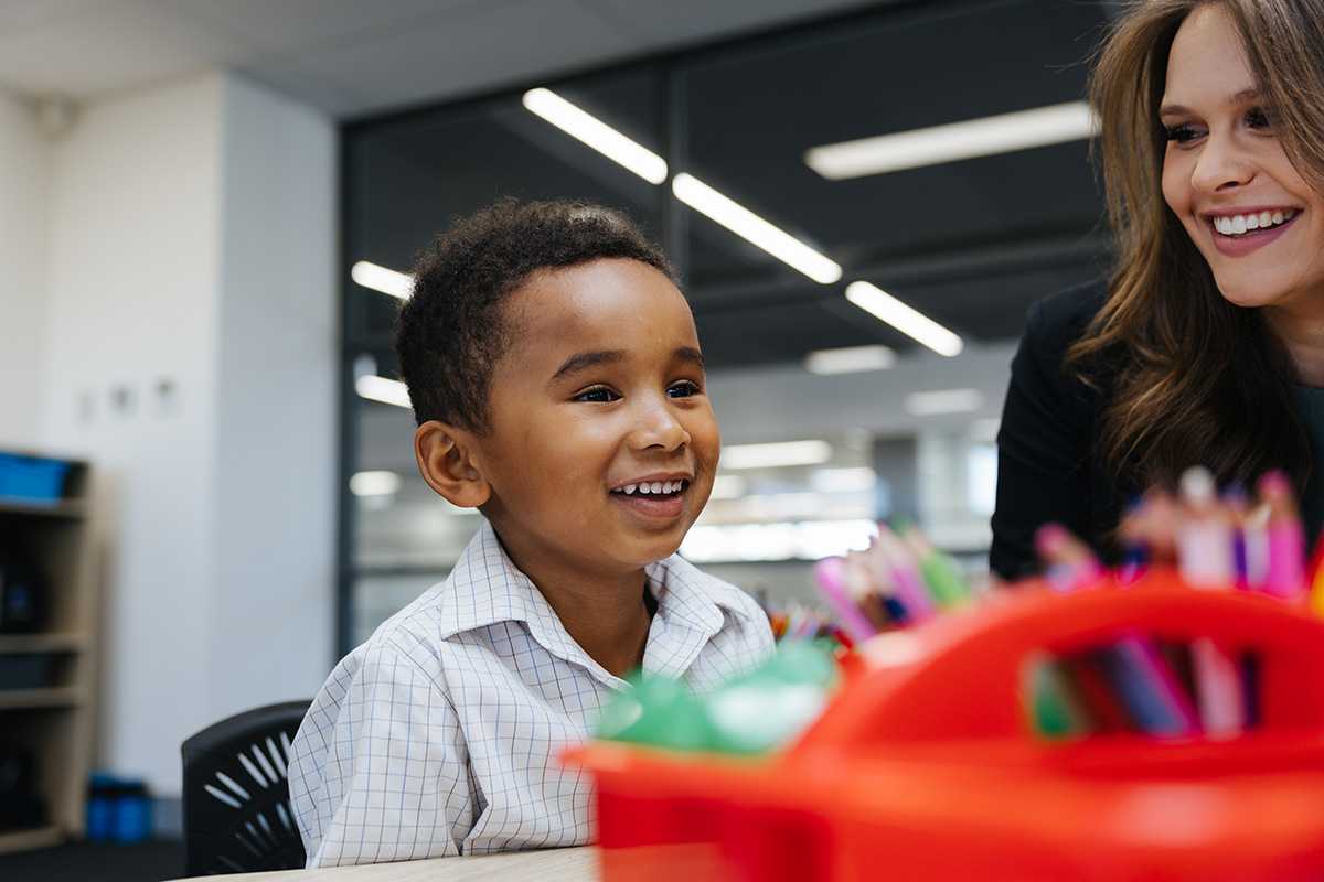 Teacher helping a kindergarten student at ACC Marsden Park