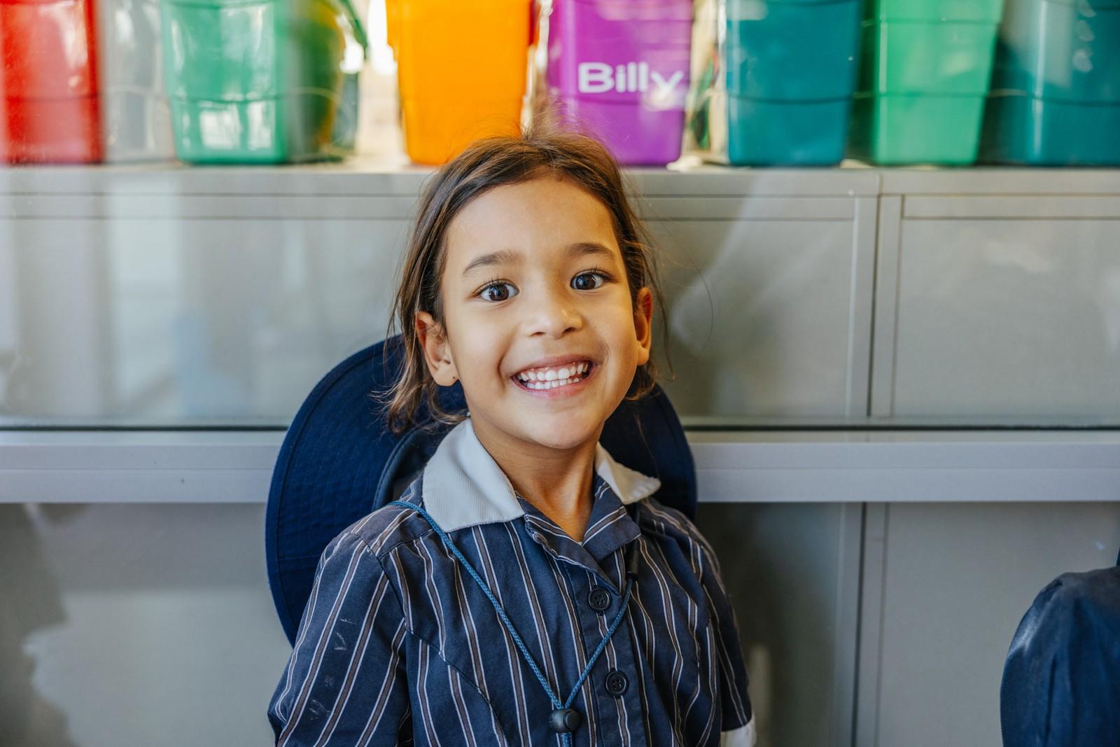 Primary student smiling in a classroom at ACC Moreton.