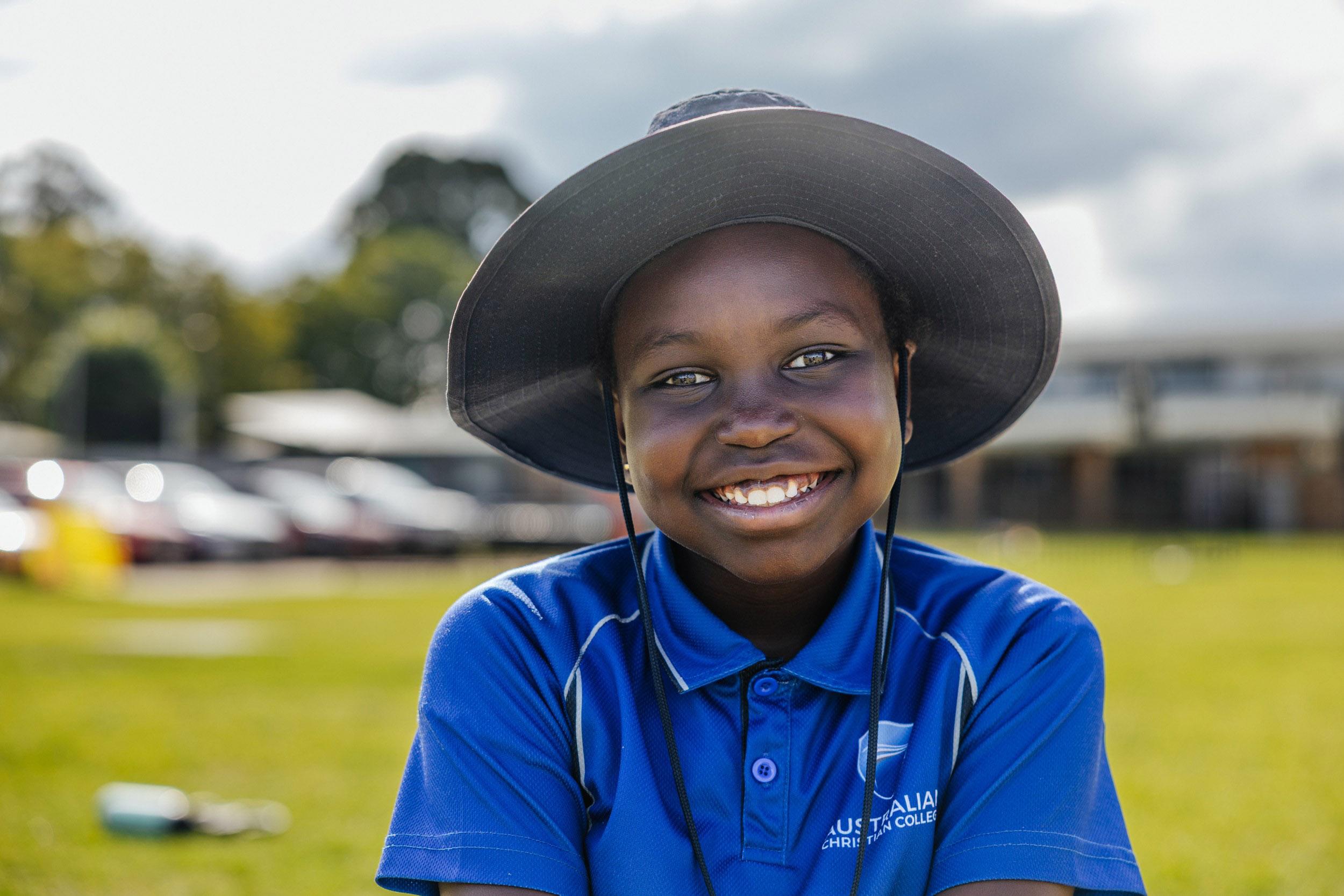 ACC Moreton student smiling on the school oval during co-curricular activities