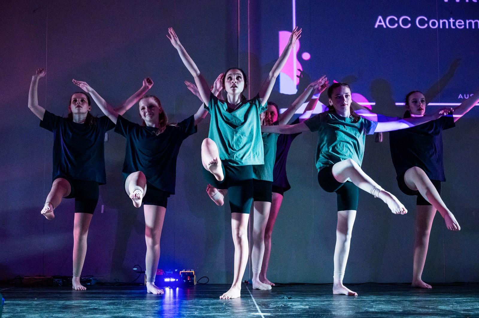 Students performing a dance routine on stage at an ACC Moreton arts showcase