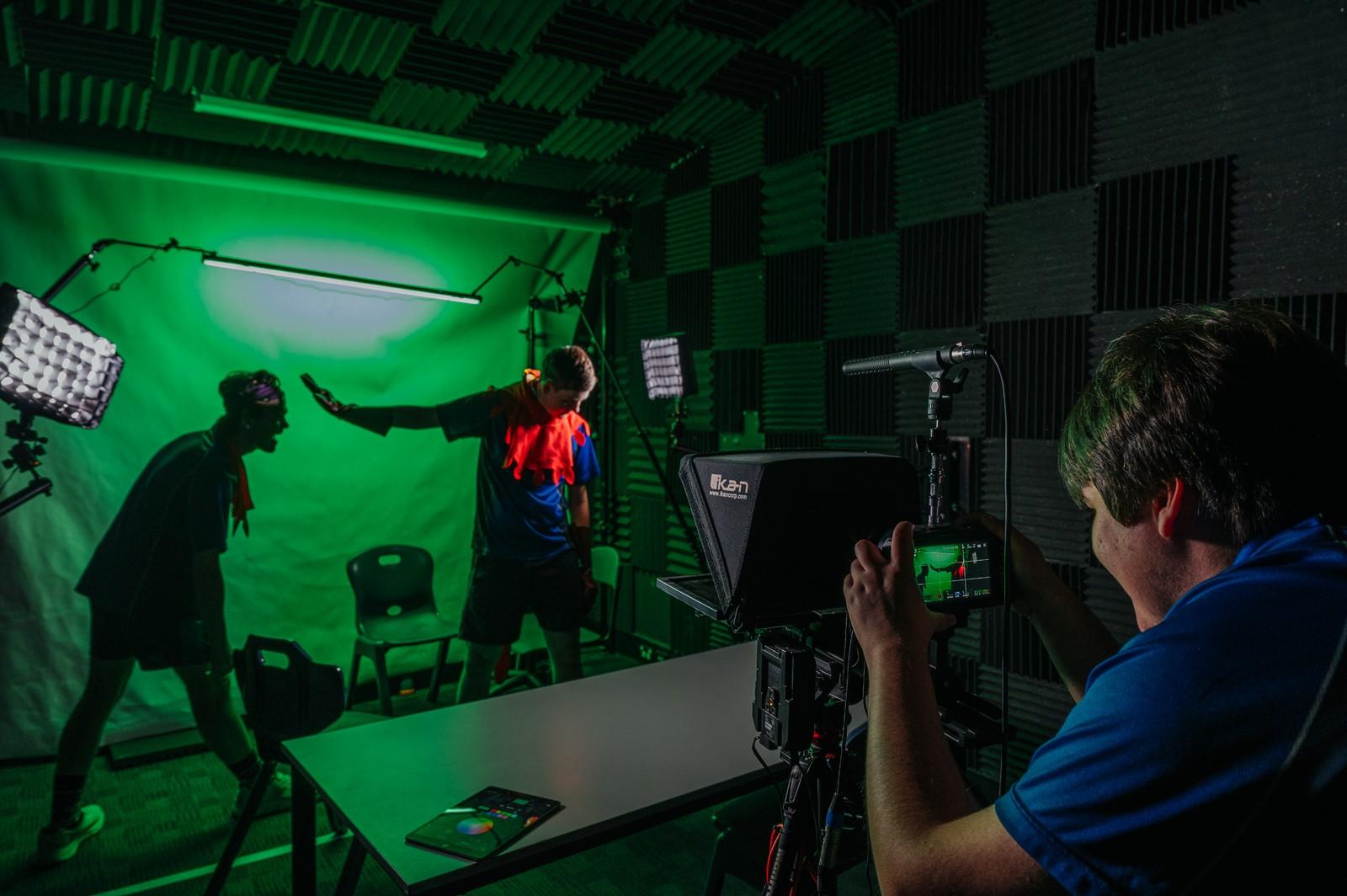 Students filming a scene in ACC Moreton's green-screen studio for the TV and Film Festival