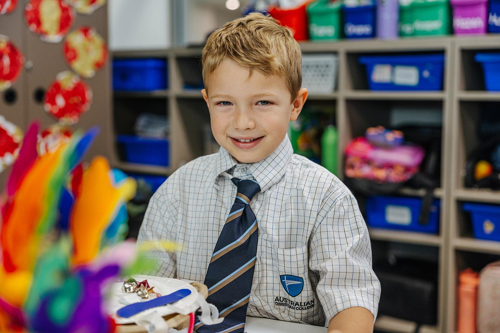 Primary student smiling during a classroom learning activity at ACC Moreton