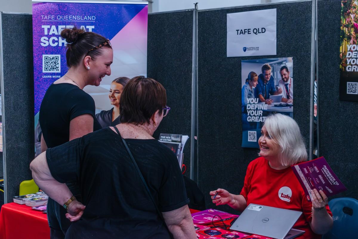 Students and families speaking with TAFE representatives at the ACC Moreton Career Expo