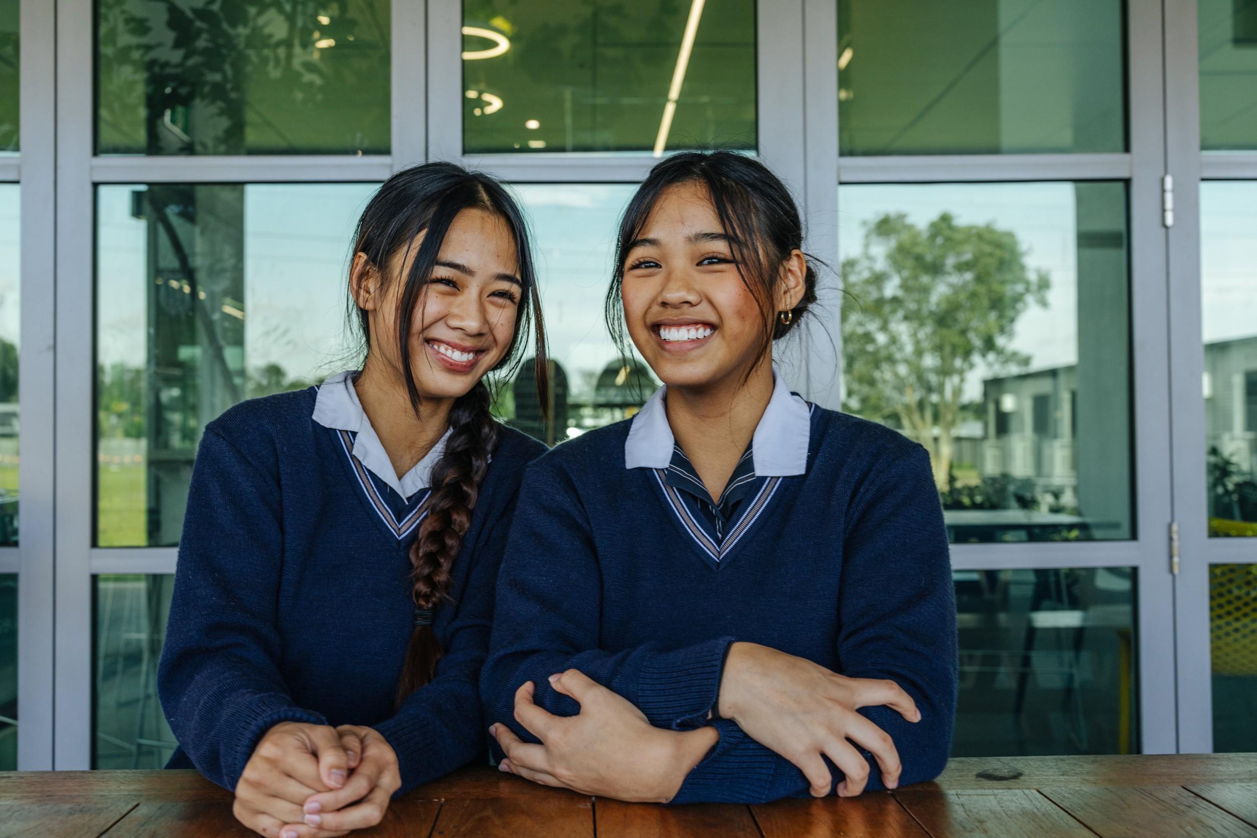 Two secondary students smiling together at ACC Moreton