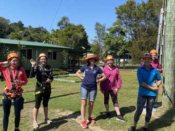 Distance education teacher with students on rope adventure course excursion