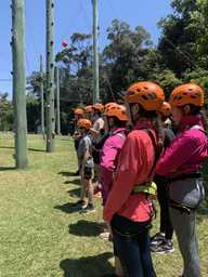 ACC Moreton students on rope adventure course excursion listening to instructor