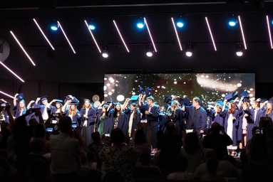 Queensland distance education students on stage in graduation ceremony