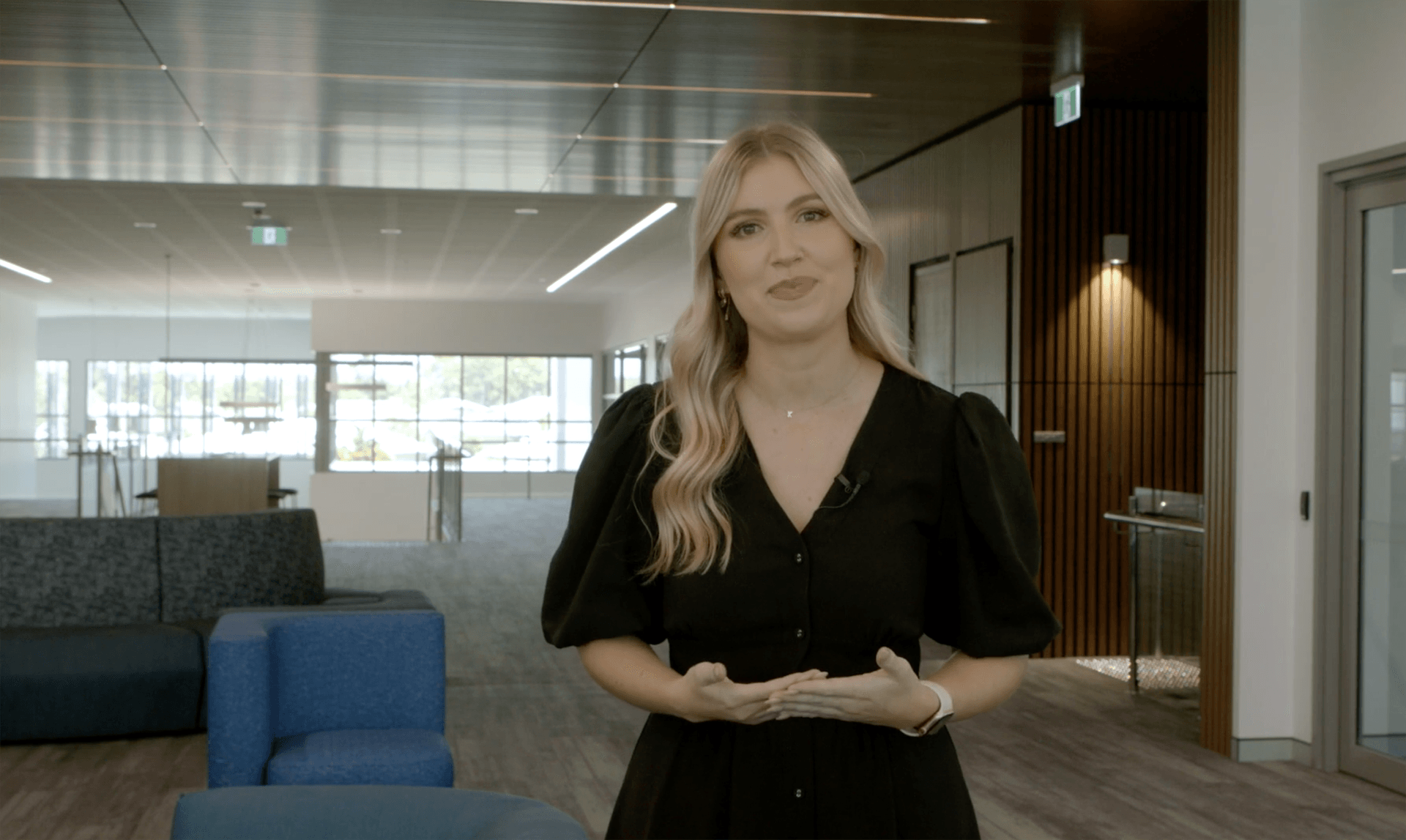 female presenter touring inside of new school building