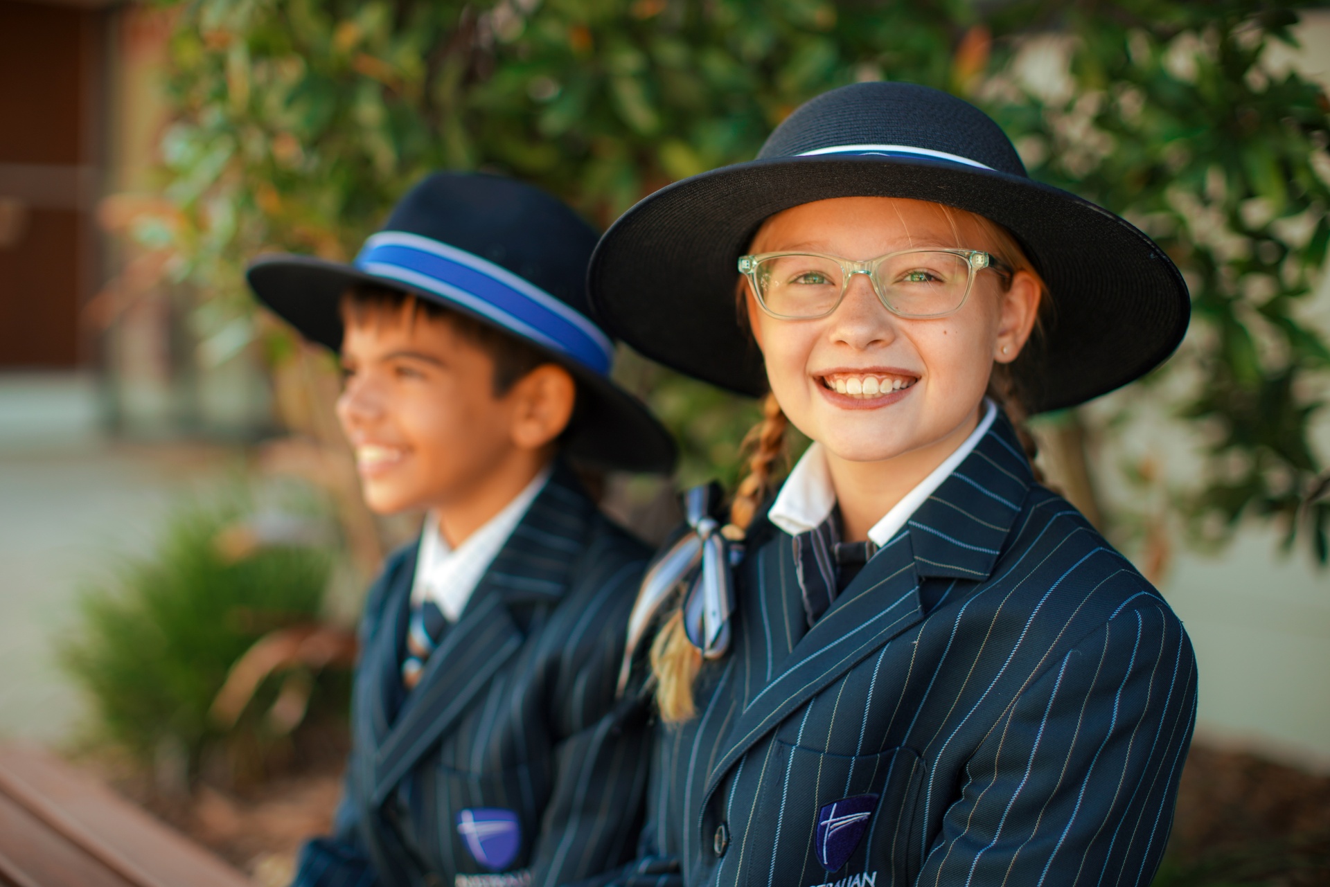 smiling students in ACC Moreton formal school uniform wearing blazers and broad brim hats
